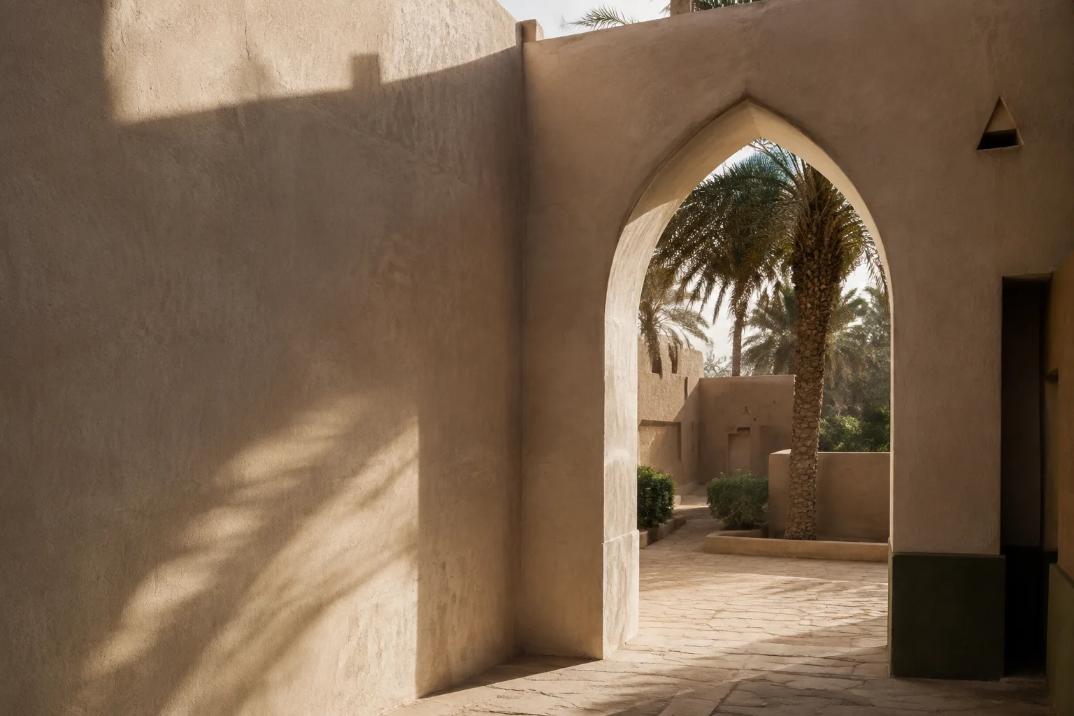 Warm gypsum architecture and date palms in a quiet Najdi courtyard